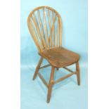 An elm stick back chair with solid seat on shaped turned legs and stretchers, (possibly Yealmpton).