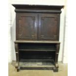 An early-19th century rosewood cabinet on stand, the moulded cornice drawer above a pair of doors