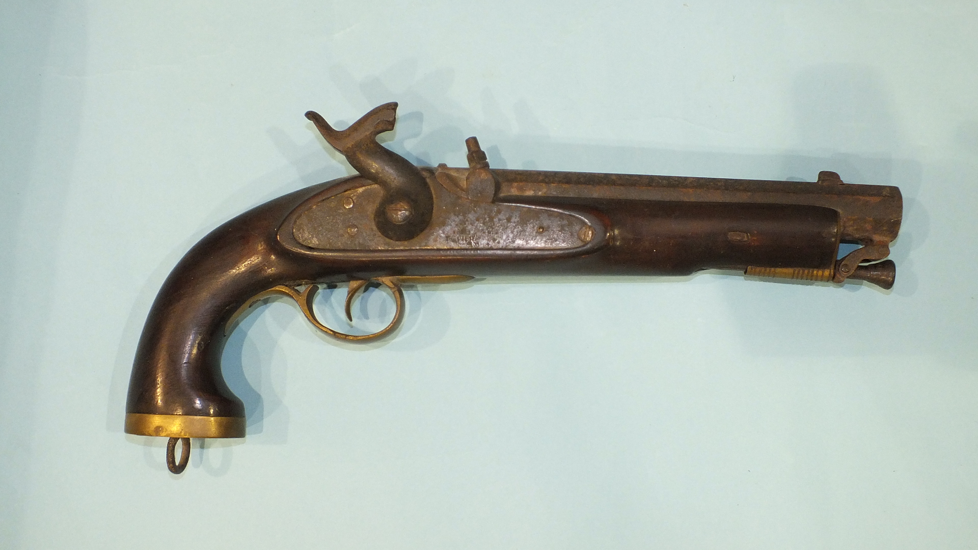 A 19th century percussion pistol with tower lock, brass fittings and swivel ram rod, the octagonal