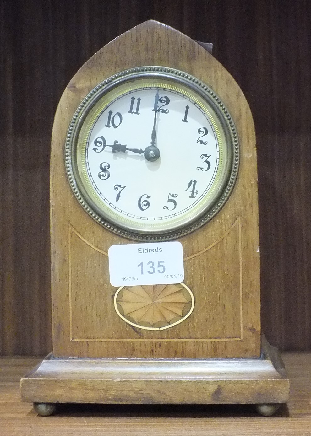 An Edwardian inlaid mahogany lancet shaped mantel clock, 20cm high and a brass standard lamp in