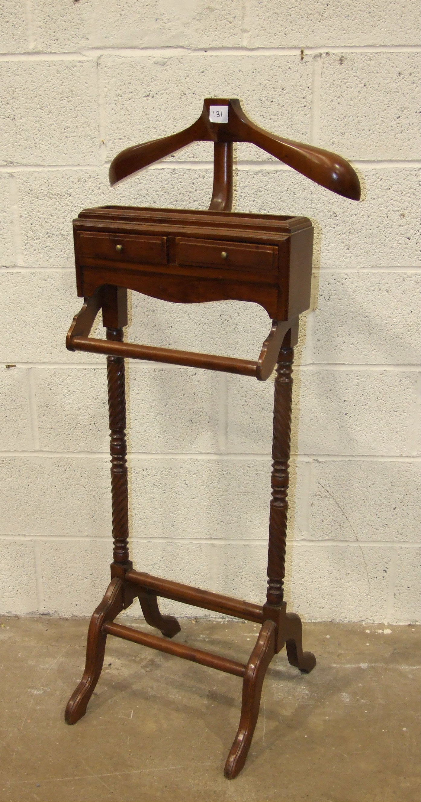 A reproduction mahogany valet stand on twist supports, 128cm high.