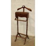 A reproduction mahogany valet stand on twist supports, 128cm high.