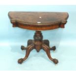 A Victorian walnut fold-over card table, the shaped top with carved border, on turned and carved
