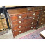 A Georgian mahogany chest of two short and three long cockbeaded drawers on bracket feet, in two