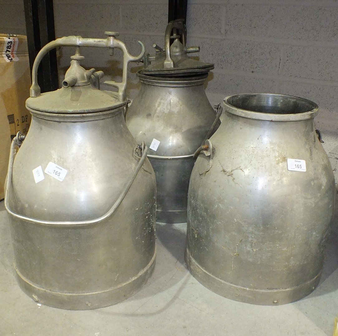 Three galvanized metal milking churns, two with lids, 52cm high.