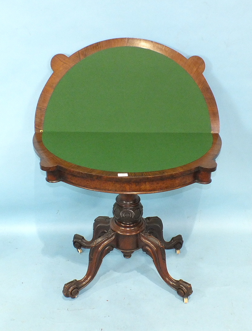 A Victorian walnut fold-over card table, the shaped top with carved border, on turned and carved - Image 2 of 2