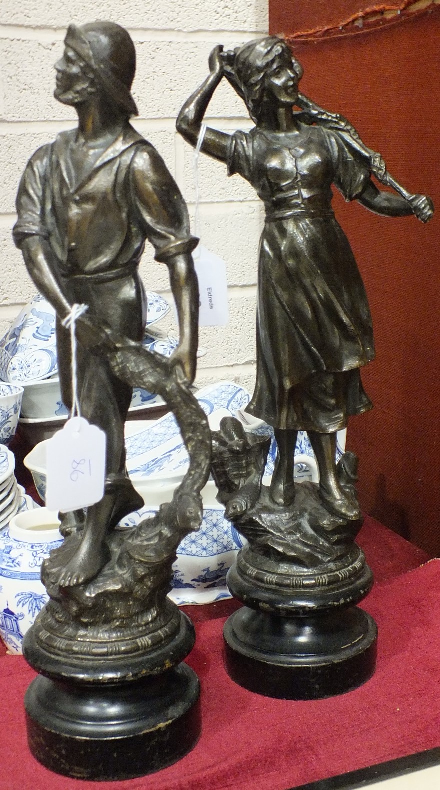 A pair of spelter figures of a fisherman and woman, 39cm.