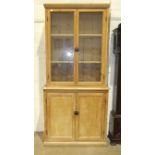 A pine dresser, the upper section fitted with a pair of glazed doors above a two-door base, 95cm