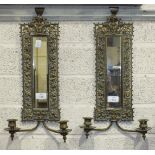 A pair of Edwardian pierced gilt metal girondole wall mirrors, each with a pair of candle sconces