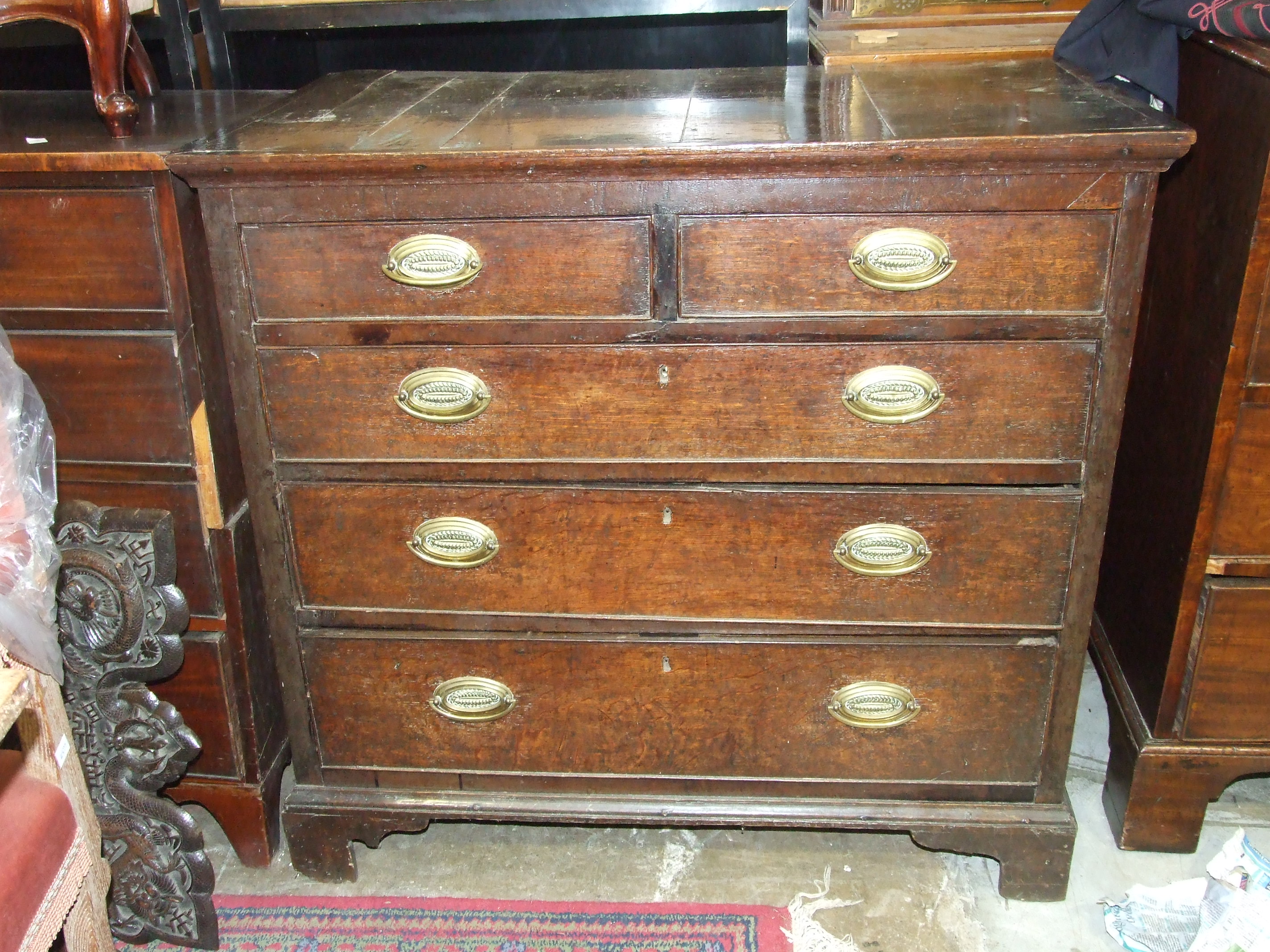 An antique oak chest of two short and three long drawers, on bracket feet, 102cm wide.