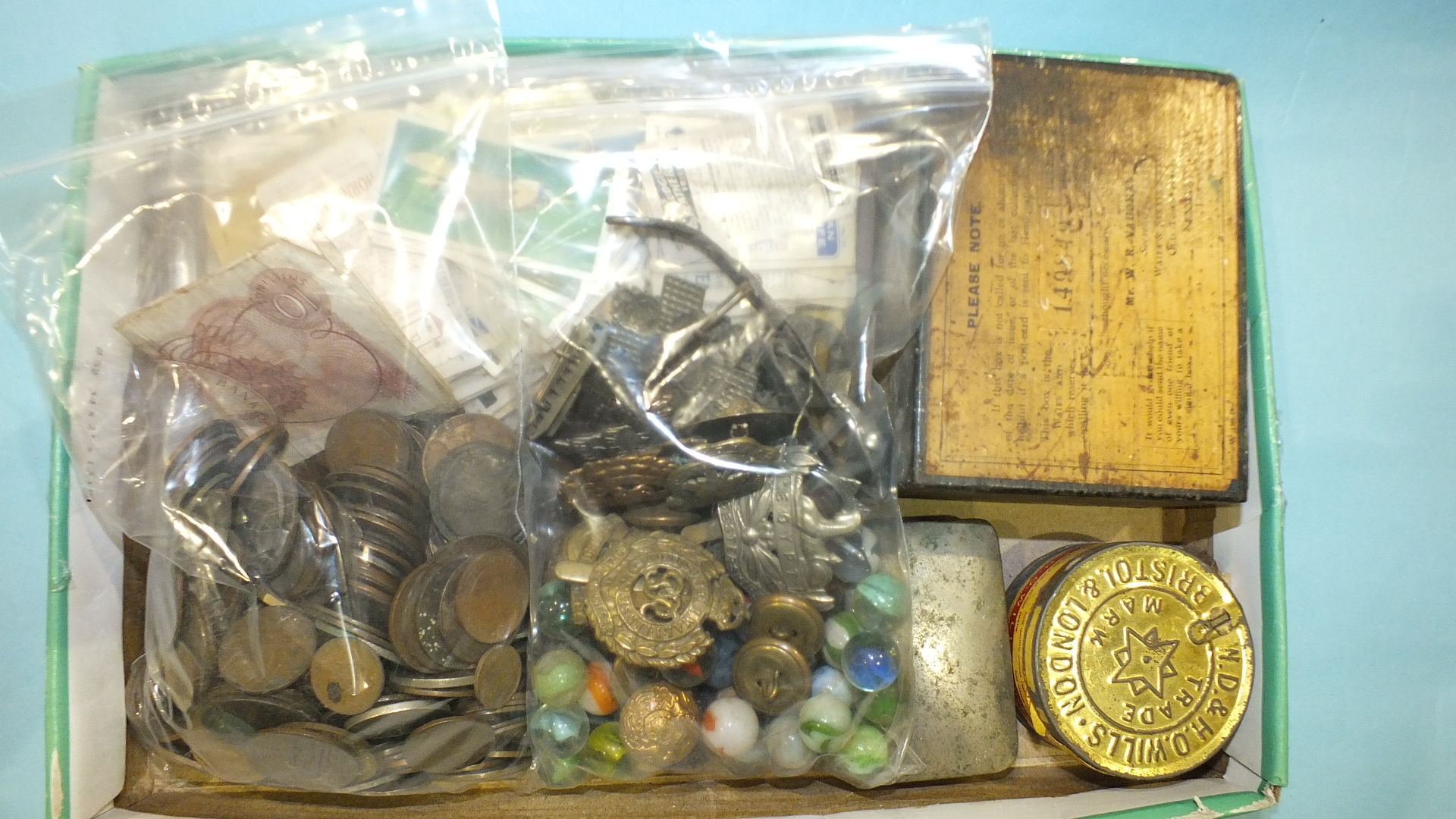 A small collection of coins, badges and other items.