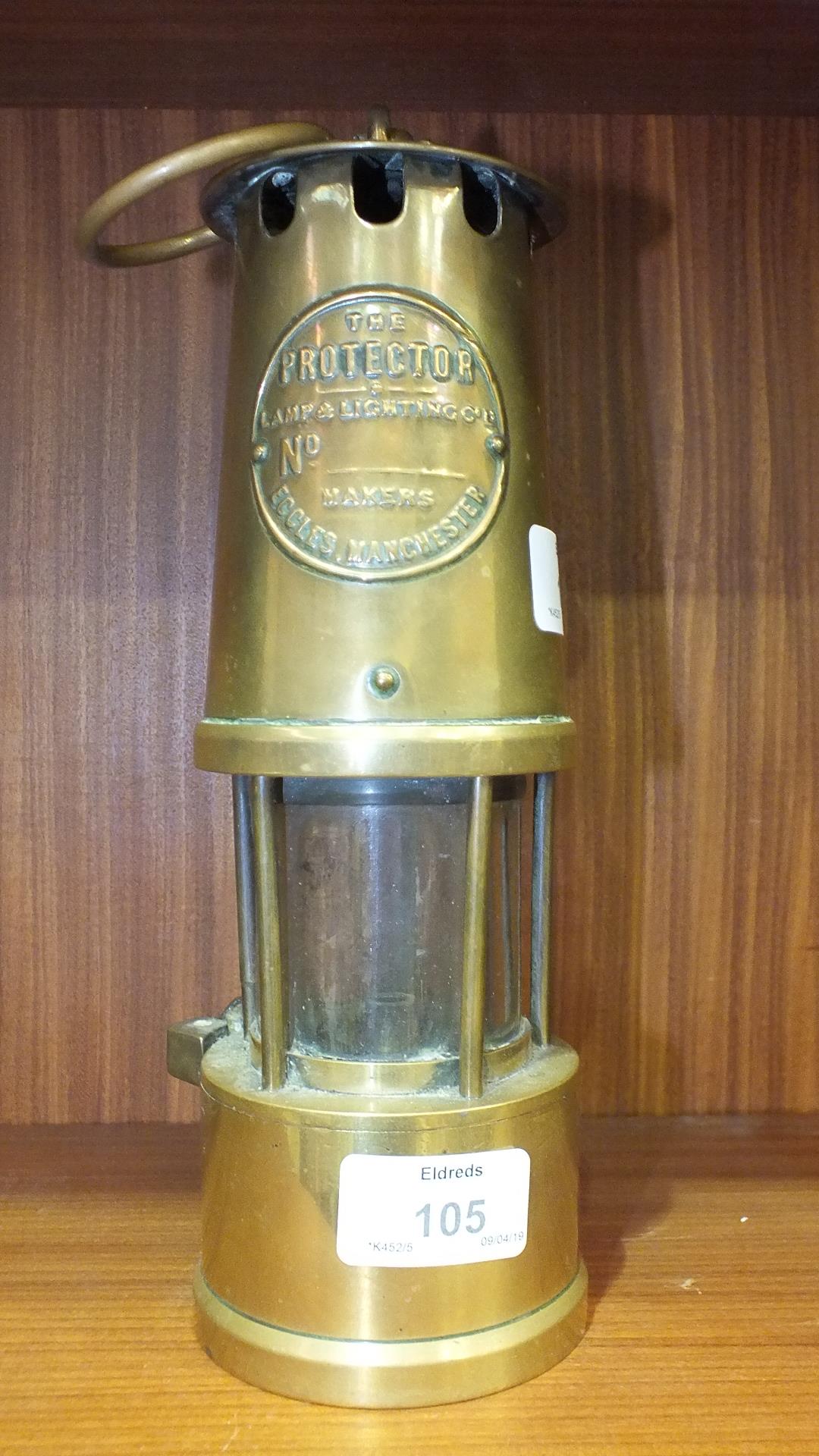 A brass miner's Lamp, The Protector, lamp & Lighting Co., Eccles, Manchester with carrying handle,