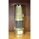 A brass miner's Lamp, The Protector, lamp & Lighting Co., Eccles, Manchester with carrying handle,