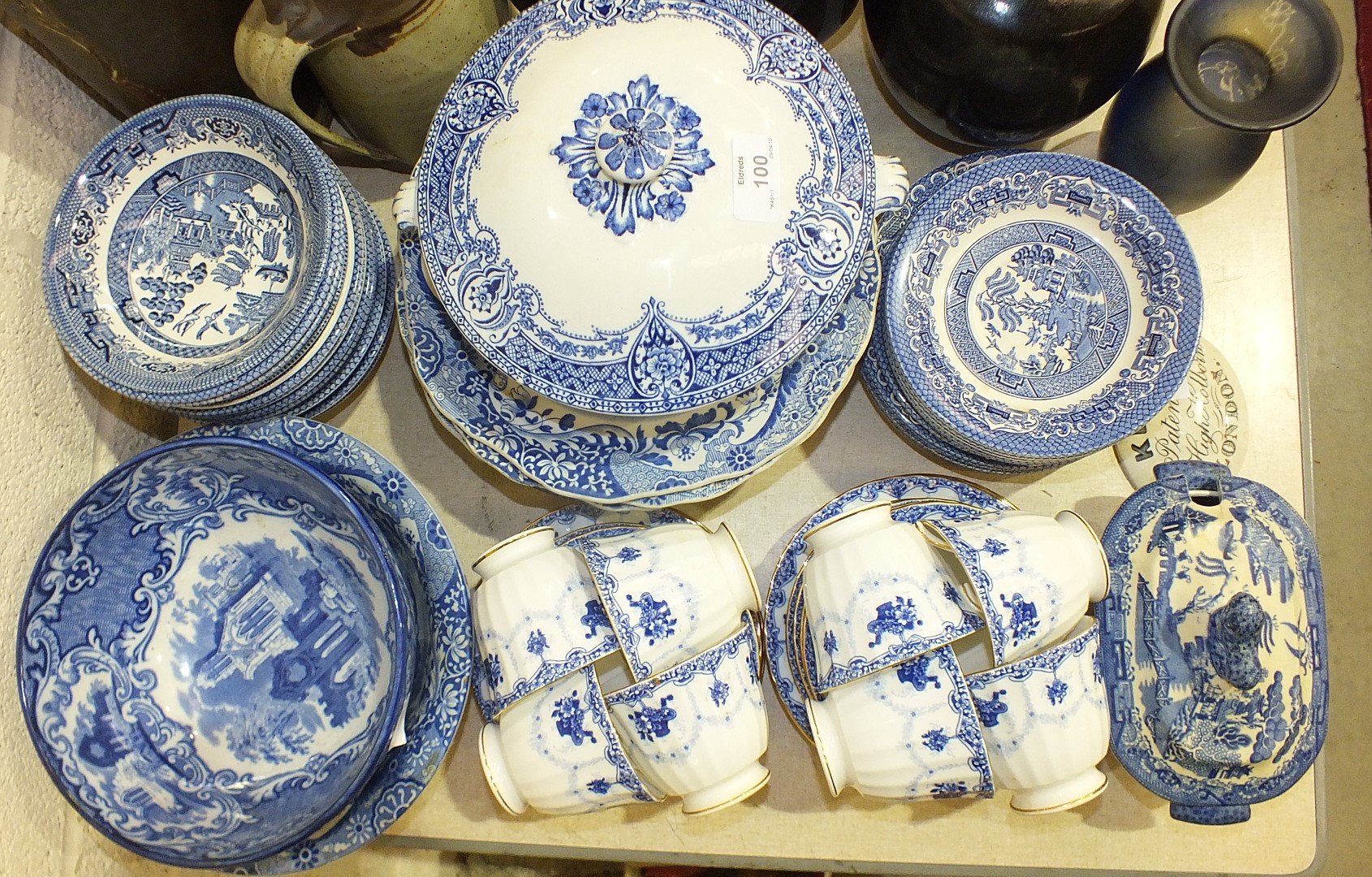 A collection of blue and white tea and dinnerware, including willow pattern, and other ceramics,