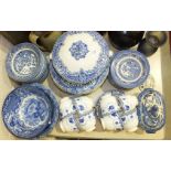 A collection of blue and white tea and dinnerware, including willow pattern, and other ceramics,