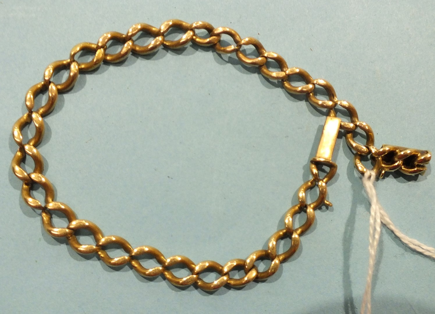 A gold curb link bracelet with concealed clasp, (unmarked, tested as 14ct, worn), 16g.