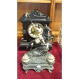 An ebonised wood mantel clock with gong-striking movement, 38cm high and a Joan of Arc painted metal