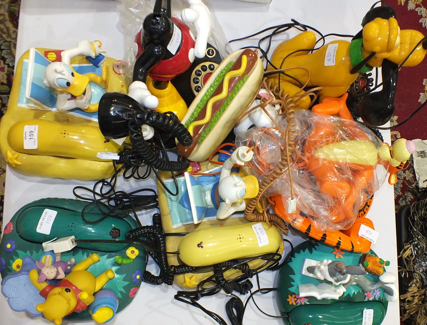 A collection of novelty telephones, mainly cartoon characters including Bugs Bunny, Donald Duck,