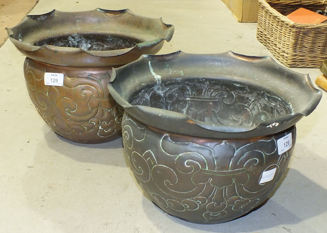 A pair of copper planters, each with embossed decoration and stamped Townshends Ltd, 31cm