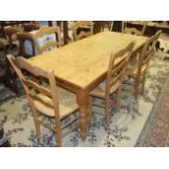 A modern pine rectangular kitchen table on turned legs, 181 x 85cm, together with a set of six