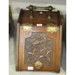 An Edwardian coal box with brass handle and hinged sloping carved front, 32cm wide.