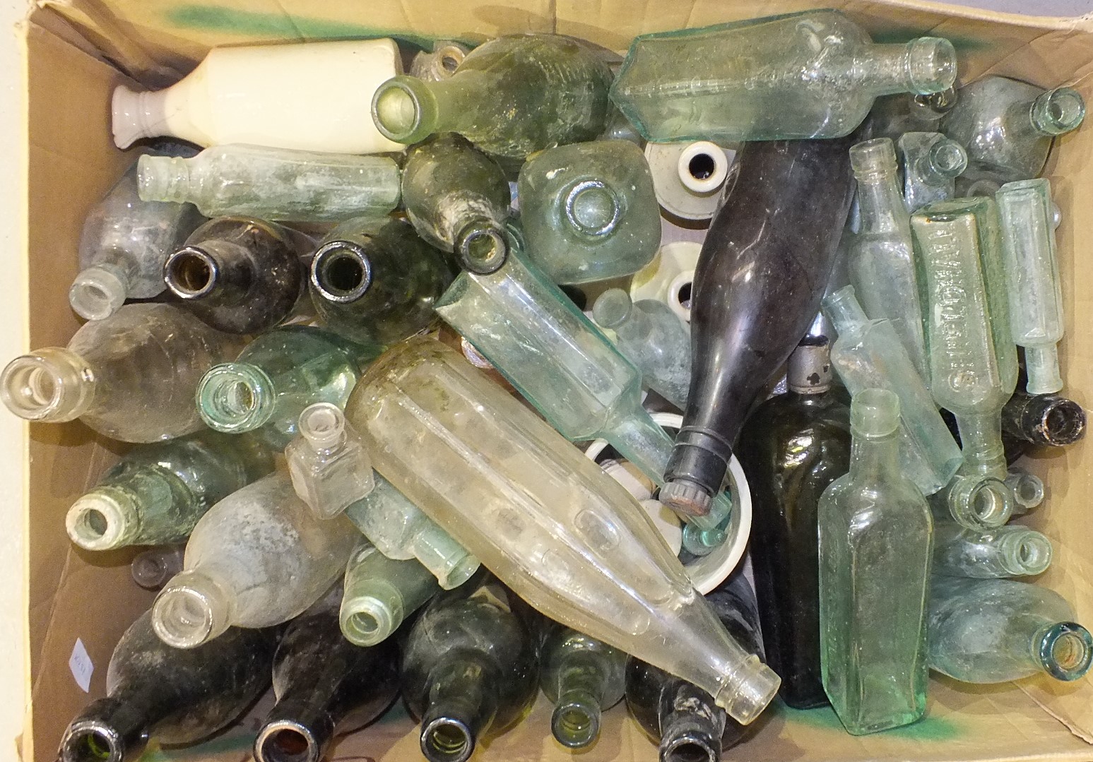 A collection of various vintage mineral and other bottles.