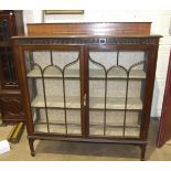 A mahogany display cabinet the rectangular top above a pair of astragal glazed doors on square