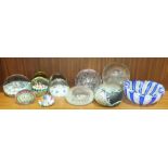 A collection of millefiori and plain glass paperweights, an oval blue and white lattice-work glass