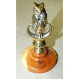 A polished plated brass car mascot in the form of an owl, 11cm high, a brass candle holder by Palmer