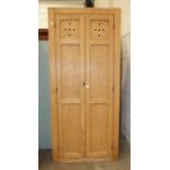 A tall stripped pine two-door larder cupboard with shelved interior, 97cm wide, 220cm high.