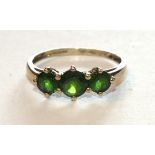 A 9ct gold ring set three round-cut hiddenite stones, size U, 2.1g.