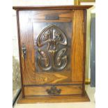 A smoker's small compendium cabinet, the door with Art Nouveau-style copper panel enclosing a fitted