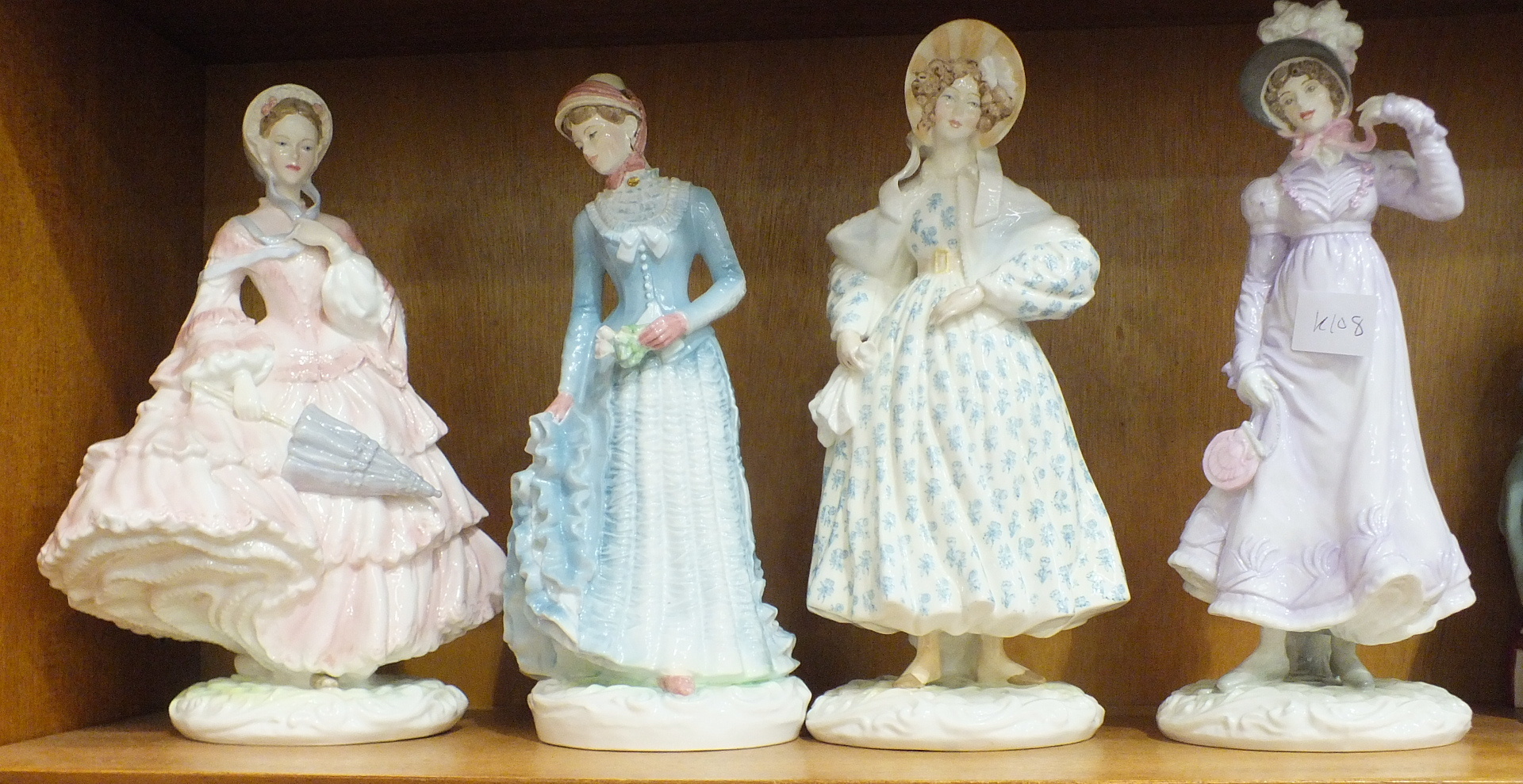 A group of four Royal Worcester figurines, 'Walking Out Dresses of the 19th Century', '1855 The