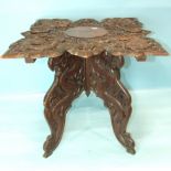 A Chinese carved wood occasional table decorated overall with dragons and characters, 60cm square,