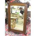 An oak-framed bevelled wall mirror, 95 x 64cm.