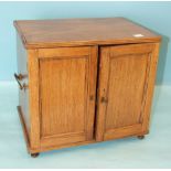 A 19th century hardwood collector's chest, having a pair of panelled doors enclosing six small