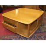An Ercol low coffee and book table fitted with two drawers, 80cm square and a matching television