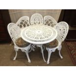 A painted alloy garden table, two chairs and a bench, table 82cm diameter.