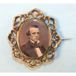 A Victorian mourning brooch, the front locket containing a photograph of a gentleman, within