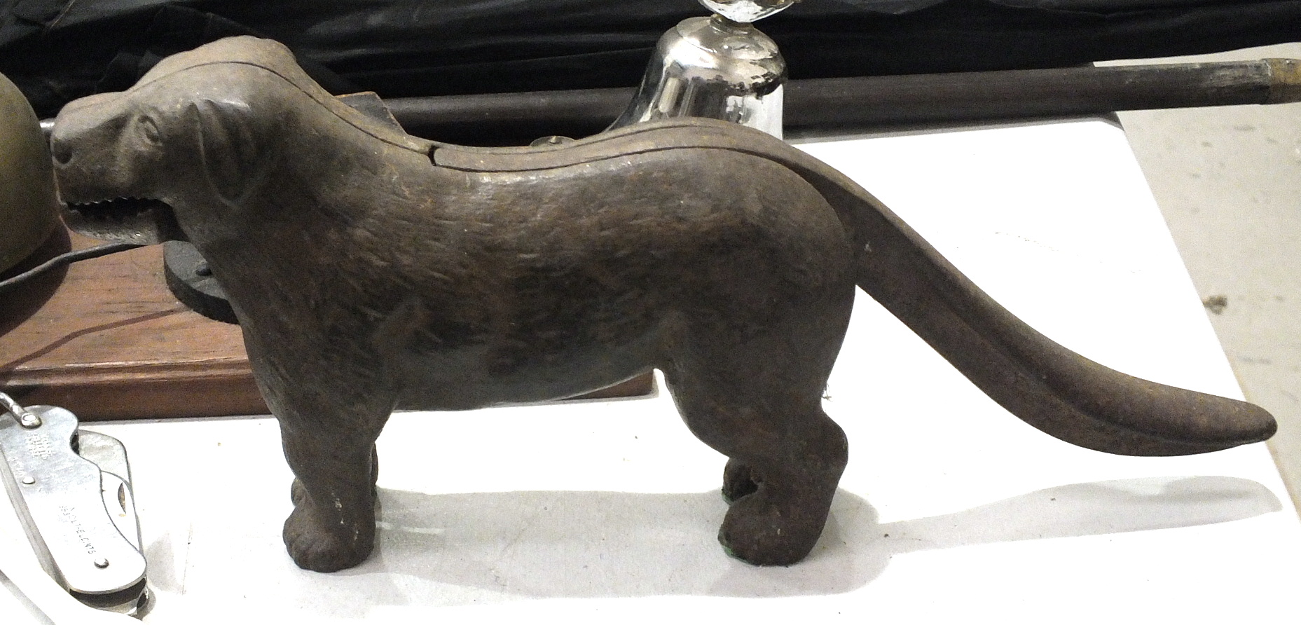 A cast iron nut cracker in the form of a dog, 30cm long and other items.