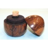 An olive wood egg-shaped travelling inkwell, the screw top over a glass bottle, 6.5cm high.