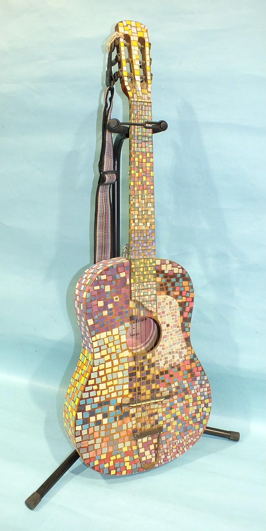 A 'Palm Beach' three-quarter-size guitar decorated all over with a mosaic of coloured paper 'tiles',