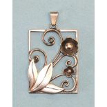 A Georg Jensen silver pendant of rectangular form, with applied flowers, tendrils and leaves, marked