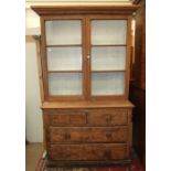 A Victorian pine dresser, the cornice above two glazed doors, two short and two long drawers,