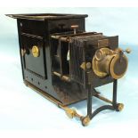 A Newton & Co. magic lantern with adjustable 9'' focus lens, bellows and Japanned tin body, in metal
