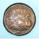 A copper circular tray embossed with a turkey, on textured ground, within piecrust border, 18cm