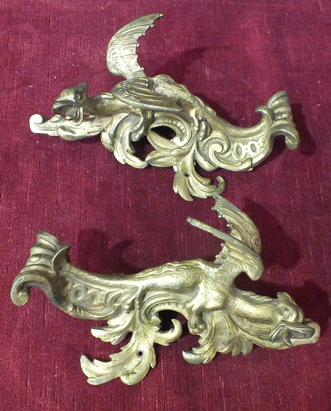 A pair of ormolu furniture mounts in the form of winged dragons, 22cm.