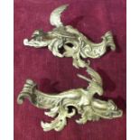 A pair of ormolu furniture mounts in the form of winged dragons, 22cm.