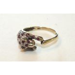 A 9ct gold ring in the form of a leopard set rubies and diamonds, size O½, 2.6g.