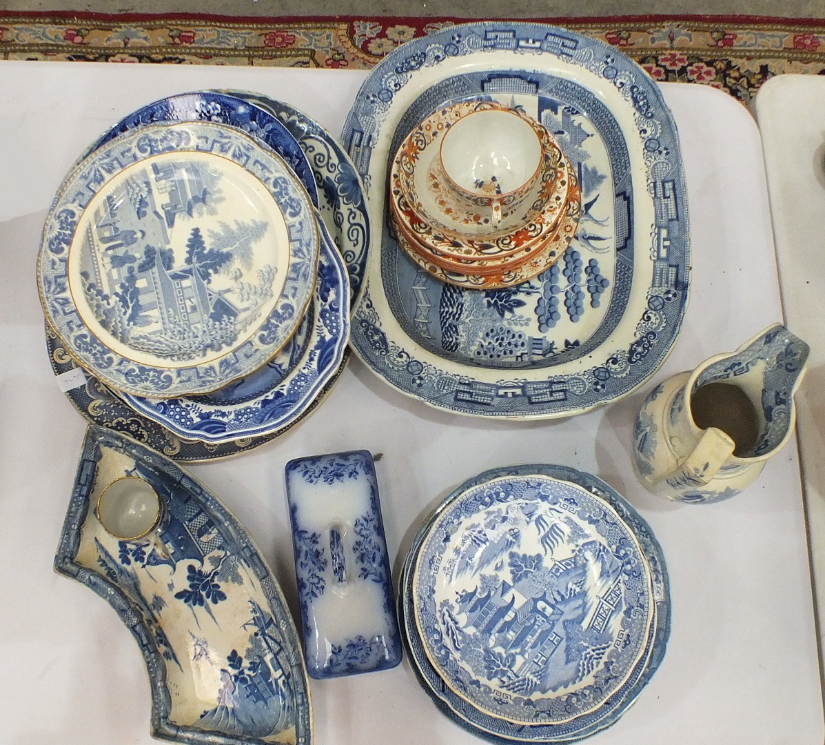 Two willow pattern blue and white joint dishes, one marked 'Ironstone China', 45cm, a transfer-